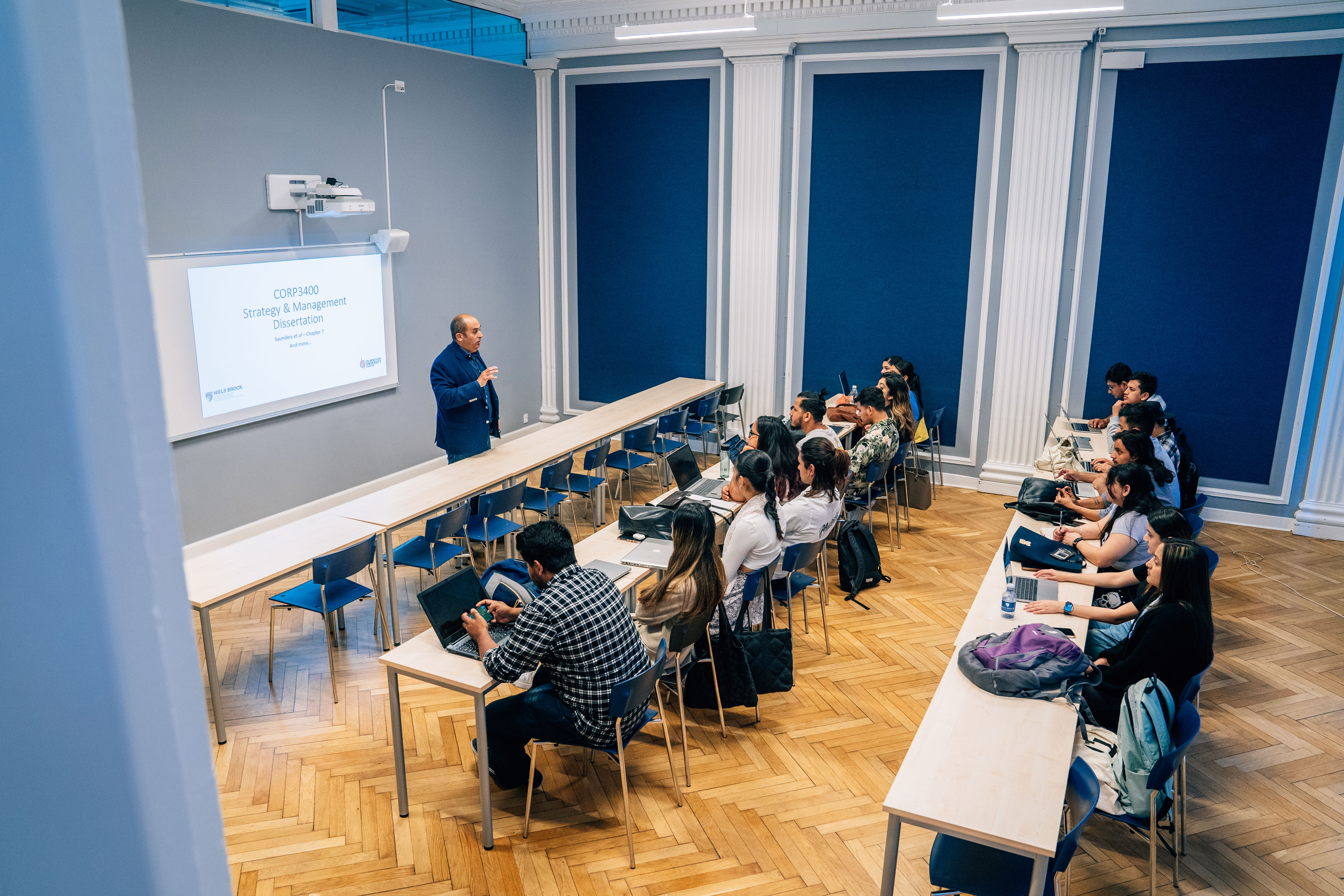 A teacher from Niels Brock Copenhagen Business College presenting a powerpoint to students from Niels Brock Copenhagen Business College